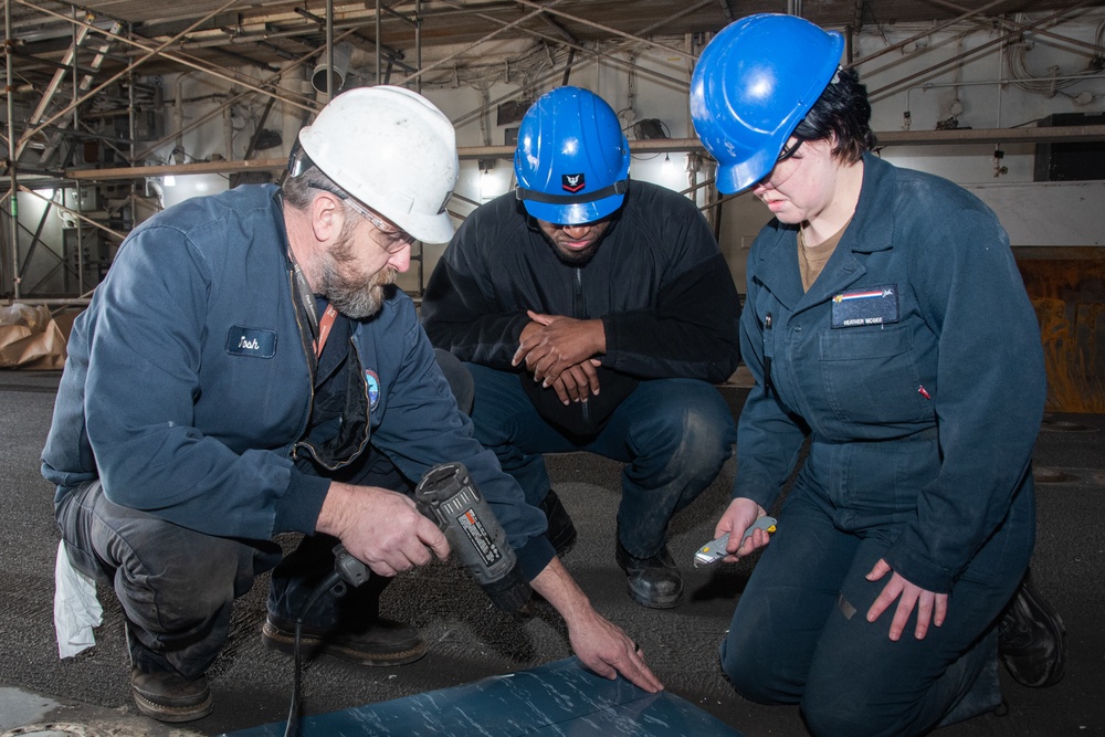 USS Ronald Reagan (CVN-76) Sailors prepare electrical matting