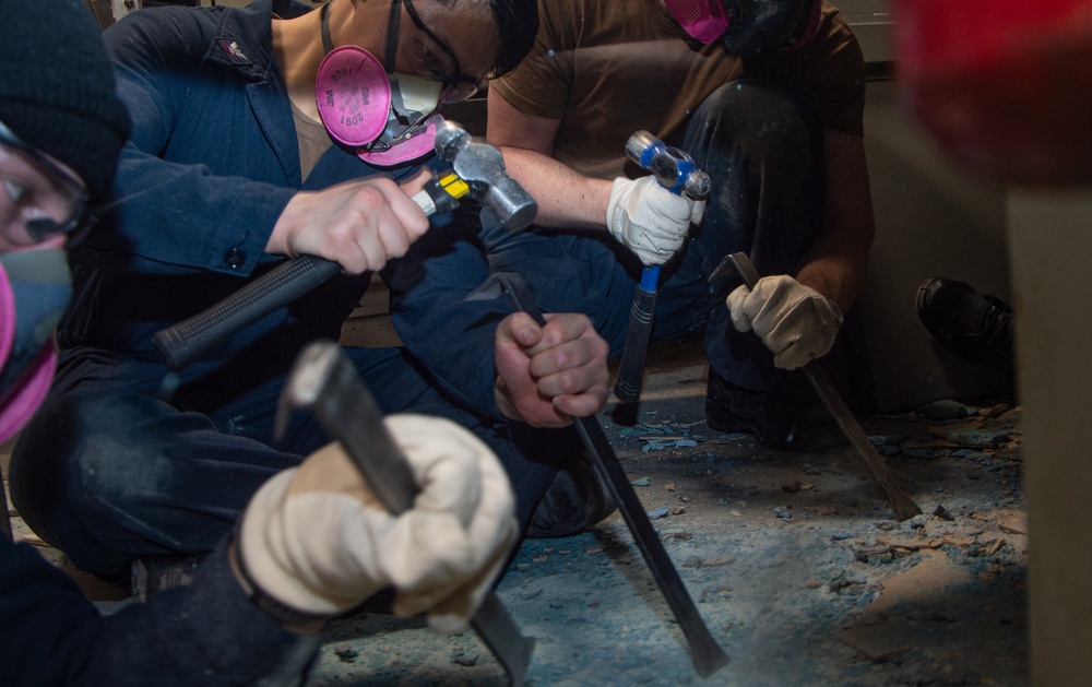 USS Ronald Reagan (CVN 76) Sailors remove floor tiles