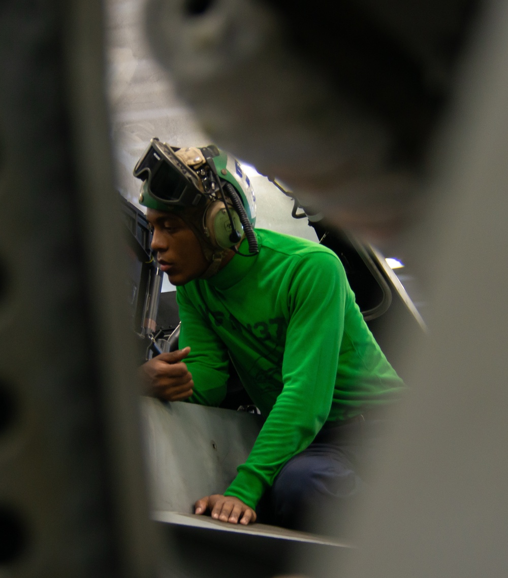 Sailors Work in the Hangar Bay Aboard Nimitz