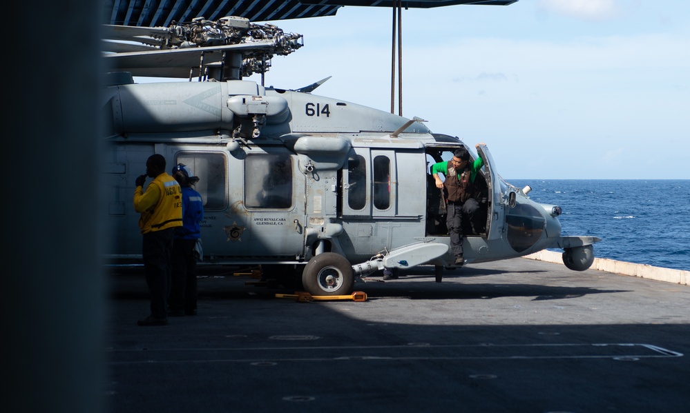 Nimitz Sailors Move a Helicopter