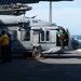 Nimitz Sailors Move a Helicopter