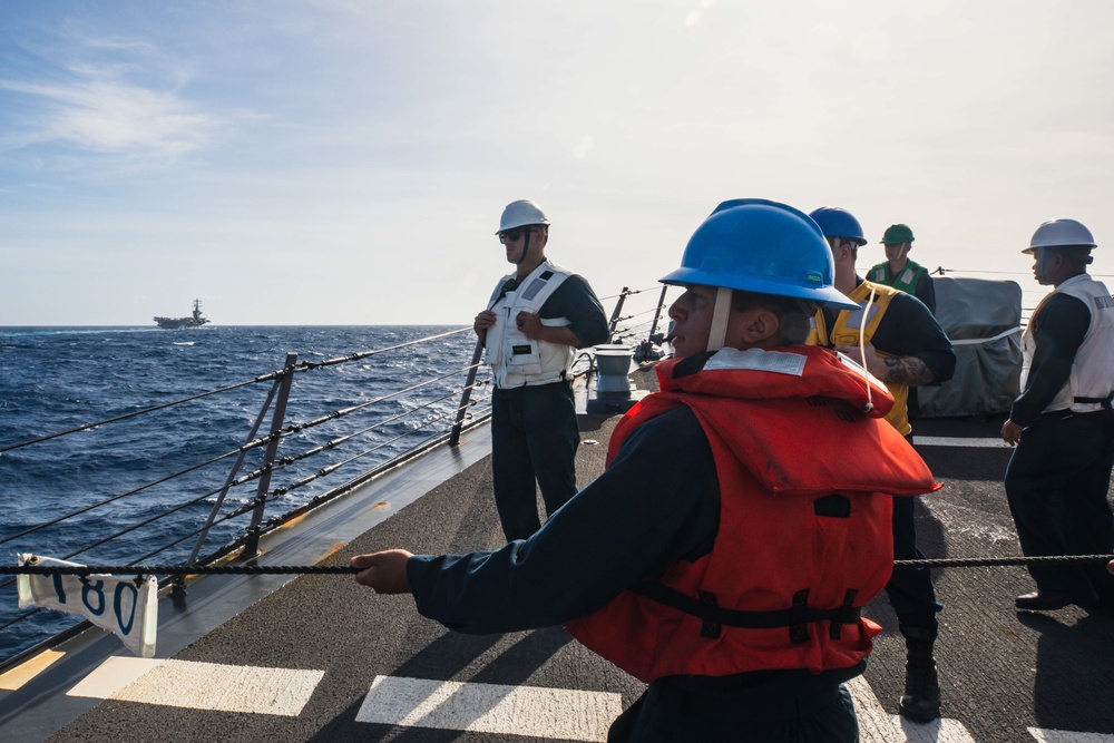 U.S. Navy Sailors heave line.