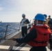 U.S. Navy Sailors heave line.