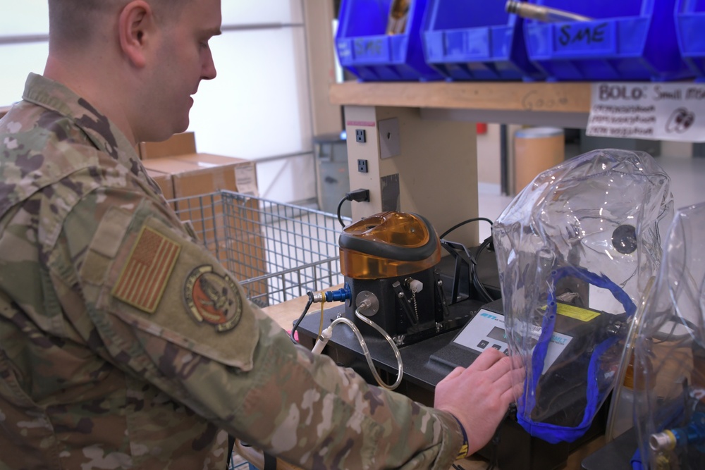 Senior Airman Randall Moore checks for leaks in gas masks