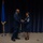 Maj. Gen. Ondra L. Berry presents Chief Master Sgt. Angela D. Ash with an American Flag at her retirement ceremony