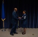 Maj. Gen. Ondra L. Berry presents Chief Master Sgt. Angela D. Ash with an American Flag at her retirement ceremony