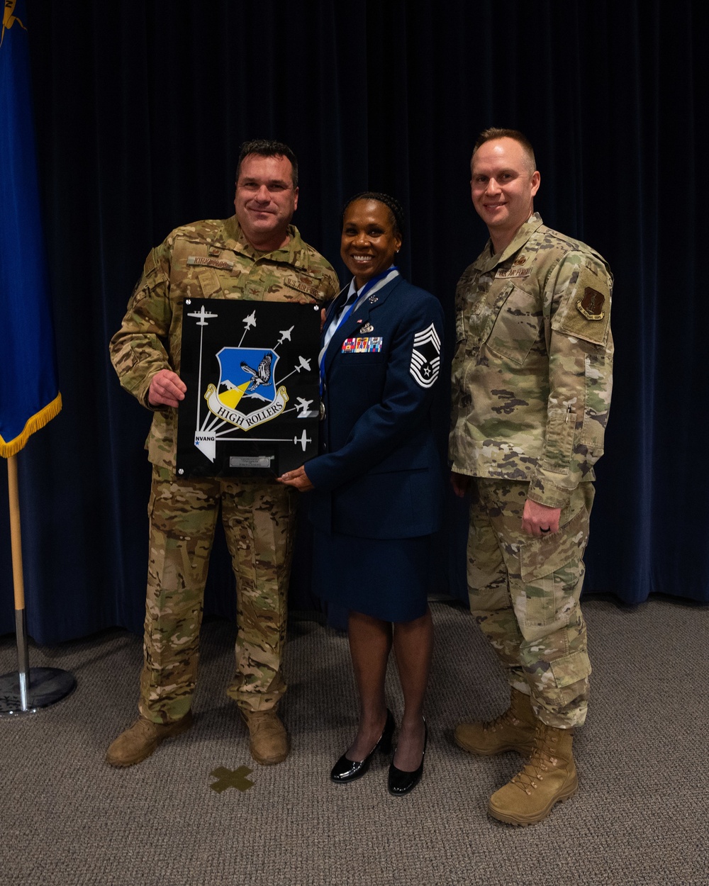 Col. Evan Kirkwood presents Chief Master Sgt. Angela D. Ash with the “High Roller Mirror” at her retirement ceremony