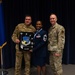 Col. Evan Kirkwood presents Chief Master Sgt. Angela D. Ash with the “High Roller Mirror” at her retirement ceremony