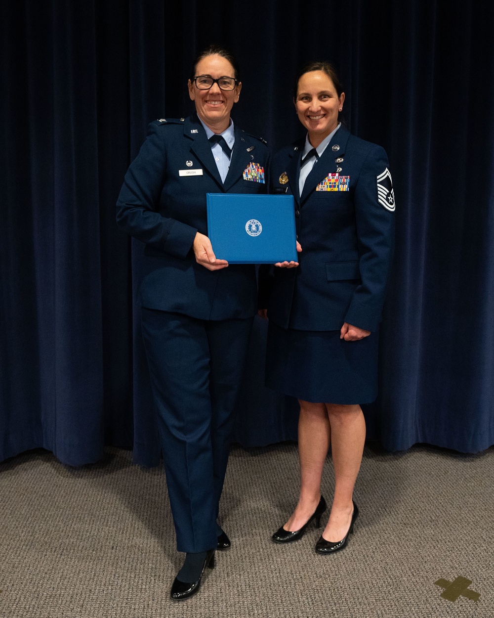 Col. Catherine Grush promotes Senior Master Sgt. Jennifer Harrell to the rank of Chief Master Sergeant