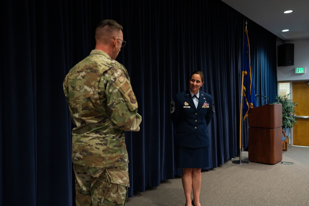 Nevada Air National Guard Command Chief Master Sgt. Kevin Brun congratulates Senior Master Sgt. Jennifer Harrell upon her promotion to the rank of Chief Master Sergeant