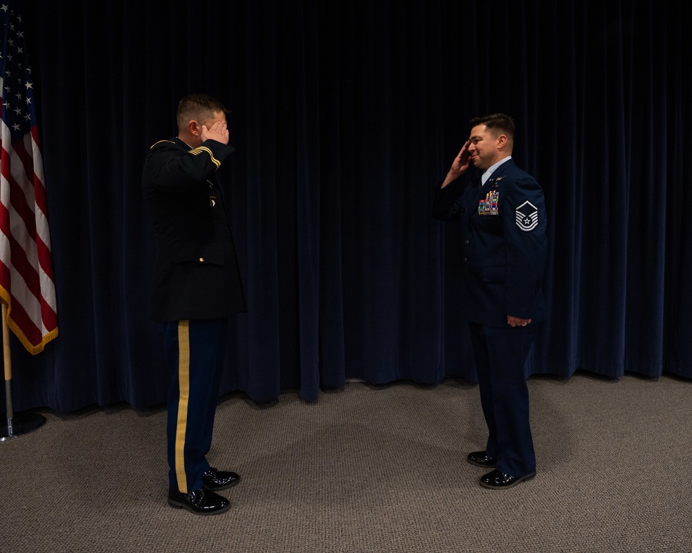 U.S. Army Maj. Dustin Petersen promotes Master Sgt. Brandan Trehal