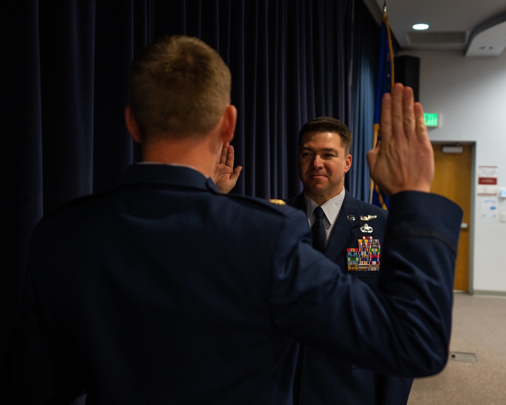 Newly promoted Senior Master Sgt. Brandan Trehal reaffirms his Oath of Enlistment