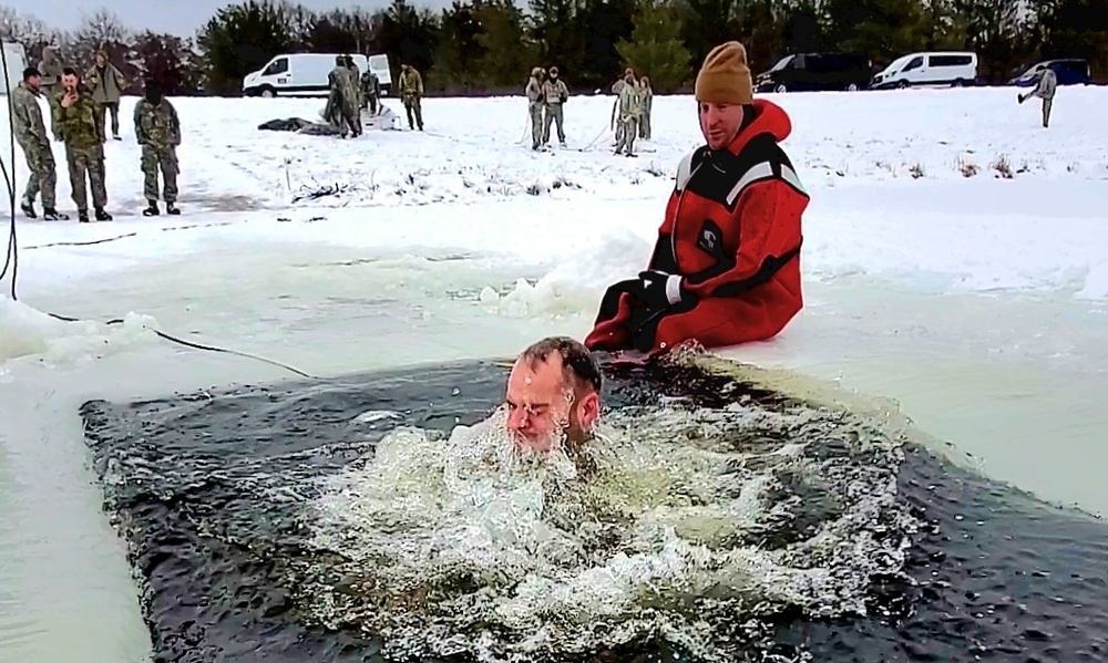 Airmen jump in icy Fort McCoy lake for January cold-water immersion training