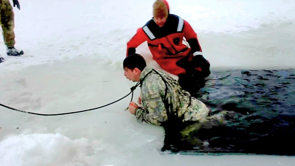 Airmen jump in icy Fort McCoy lake for January cold-water immersion training