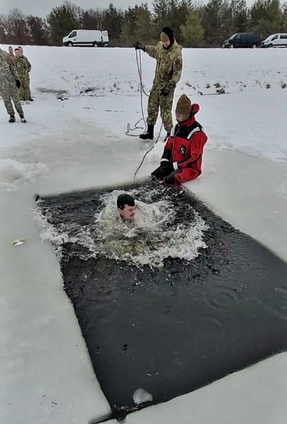 Airmen jump in icy Fort McCoy lake for January cold-water immersion training