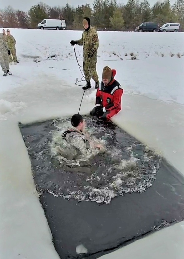 Airmen jump in icy Fort McCoy lake for January cold-water immersion training