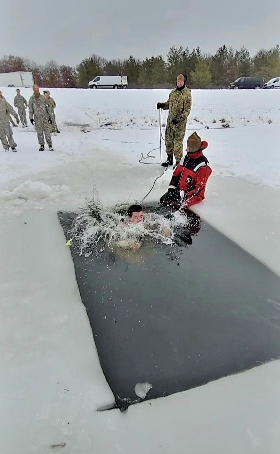 Airmen jump in icy Fort McCoy lake for January cold-water immersion training