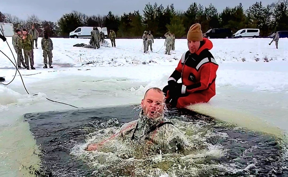 Airmen jump in icy Fort McCoy lake for January cold-water immersion training