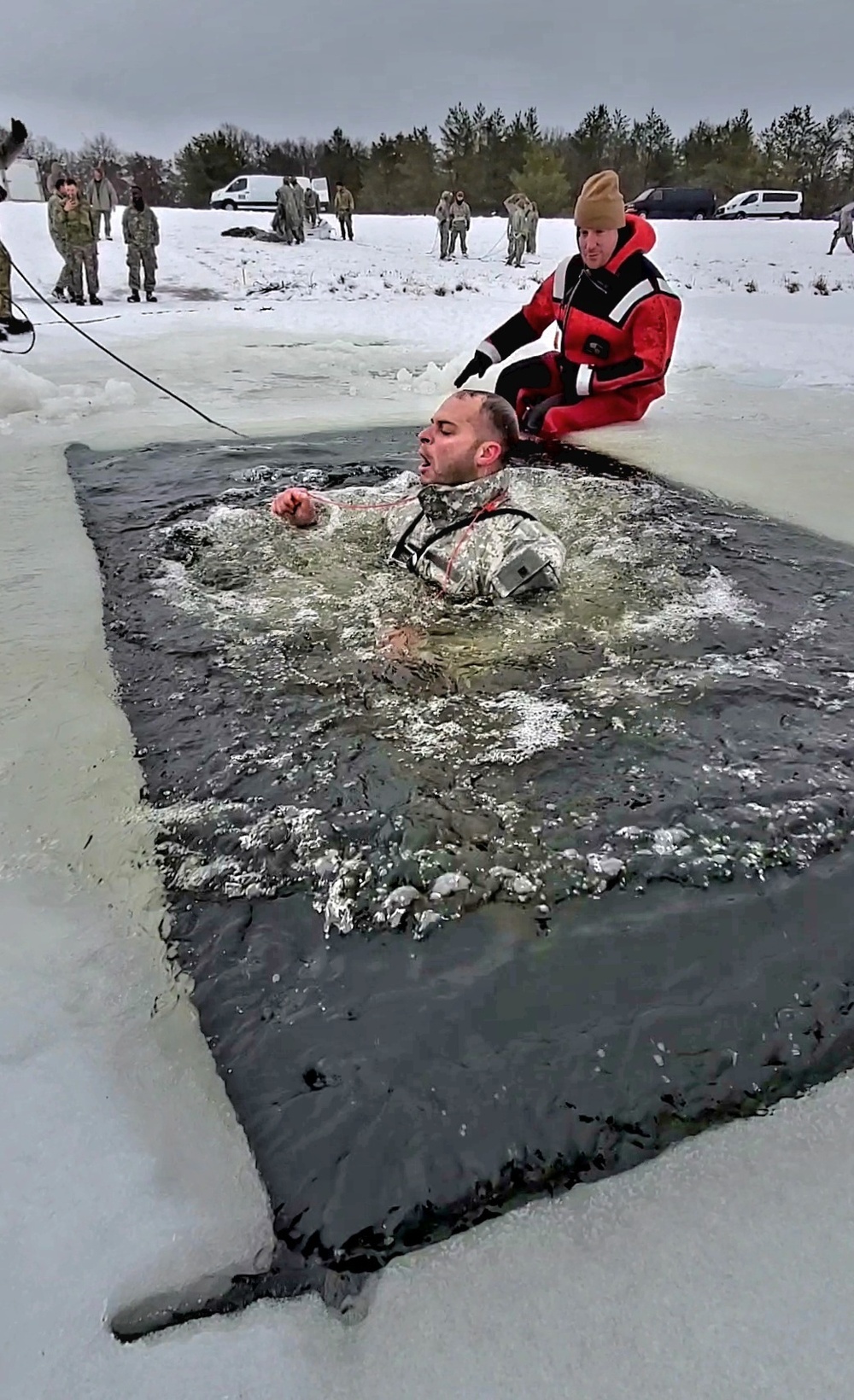 Airmen jump in icy Fort McCoy lake for January cold-water immersion training