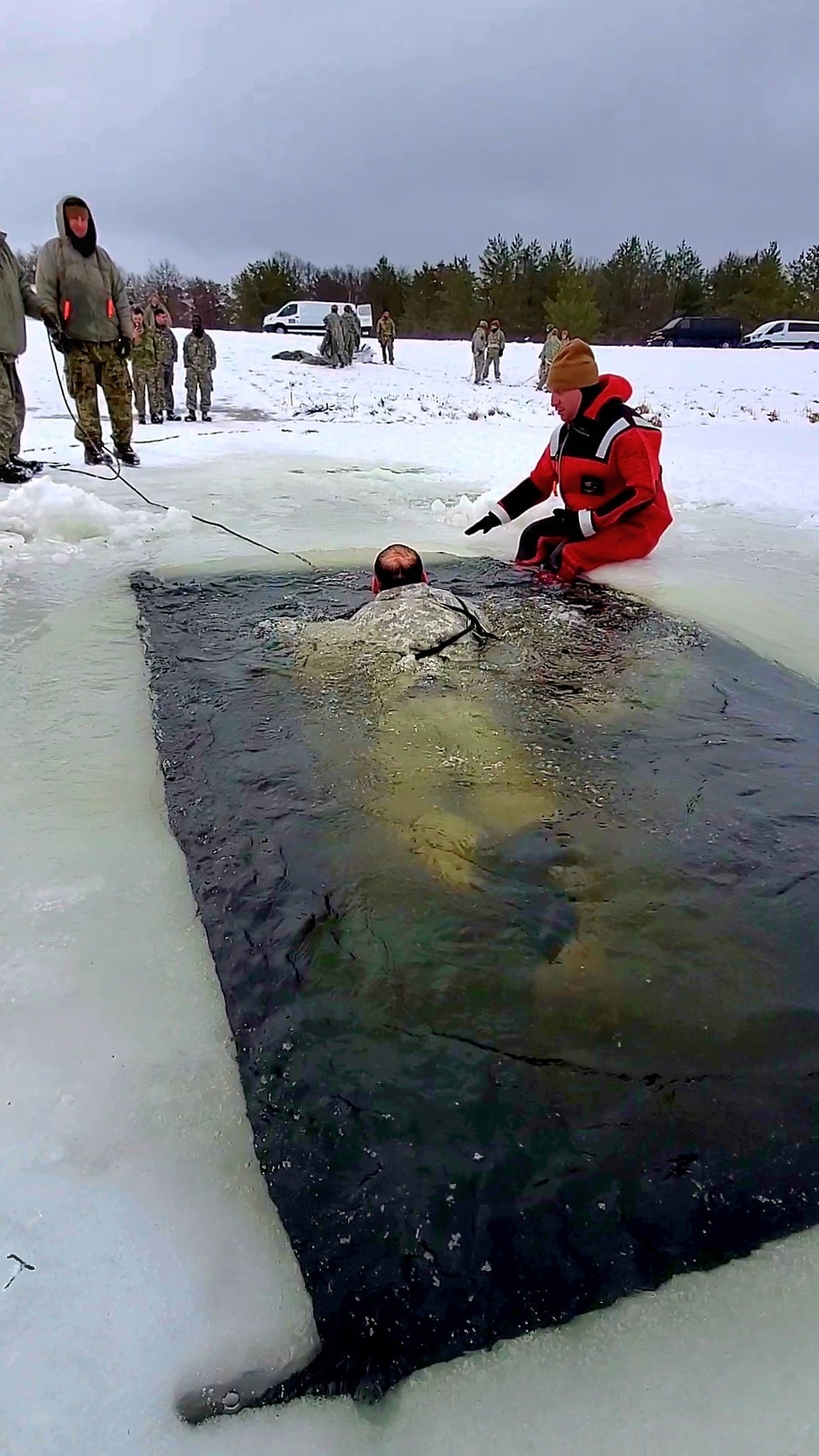 Airmen jump in icy Fort McCoy lake for January cold-water immersion training