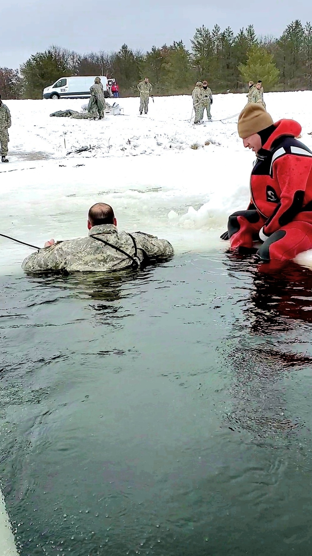 Airmen jump in icy Fort McCoy lake for January cold-water immersion training