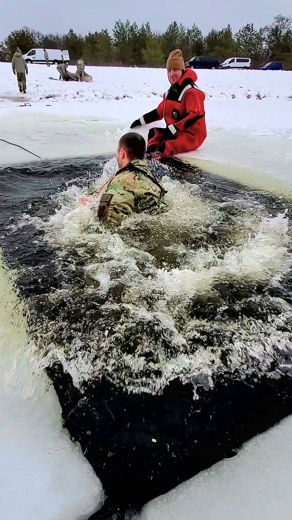 Airmen jump in icy Fort McCoy lake for January cold-water immersion training