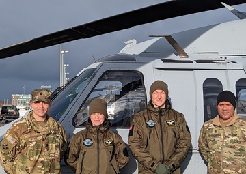 Officers from a Latvian Air Force Squadron pose with TF Desert Knight Commander and Command Sgt. Maj.
