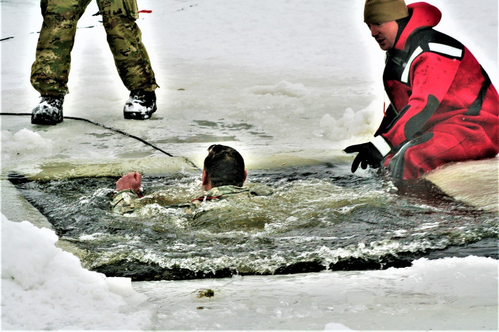 Airmen jump in icy Fort McCoy lake for January cold-water immersion training