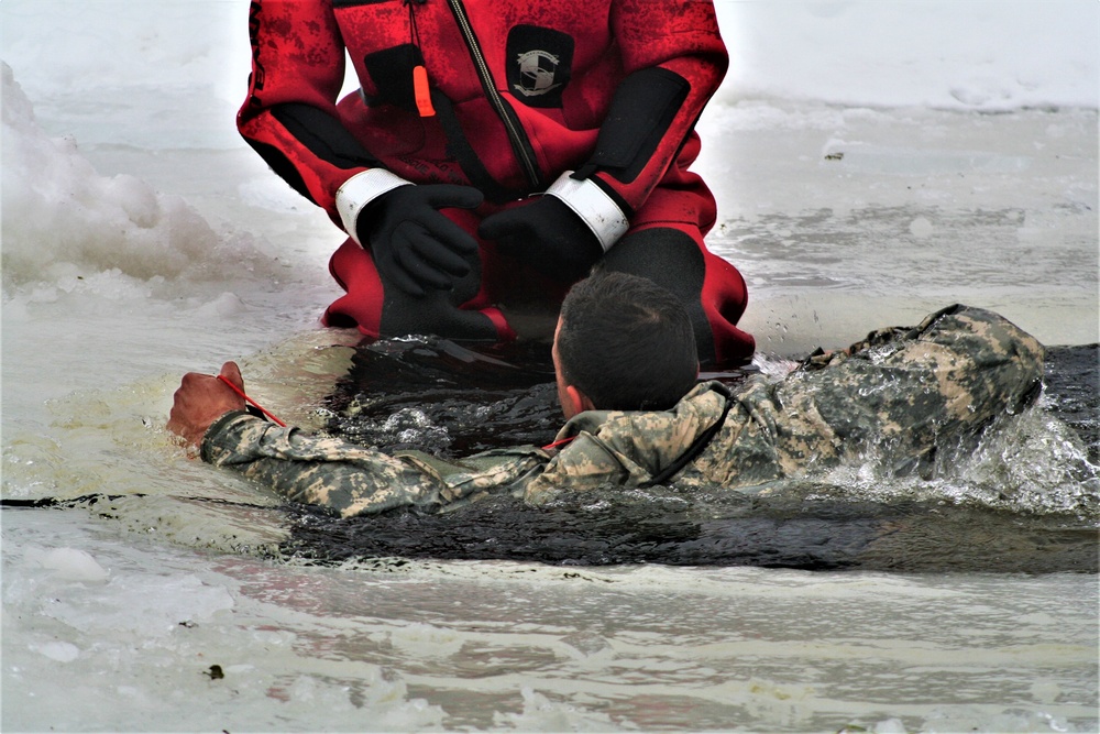 Airmen jump in icy Fort McCoy lake for January cold-water immersion training