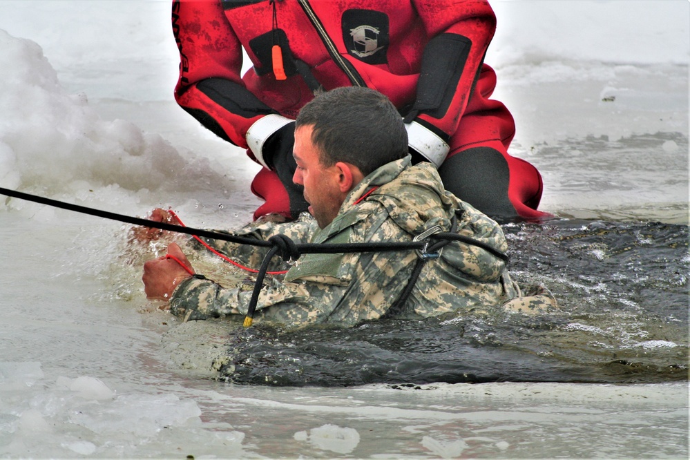 Airmen jump in icy Fort McCoy lake for January cold-water immersion training