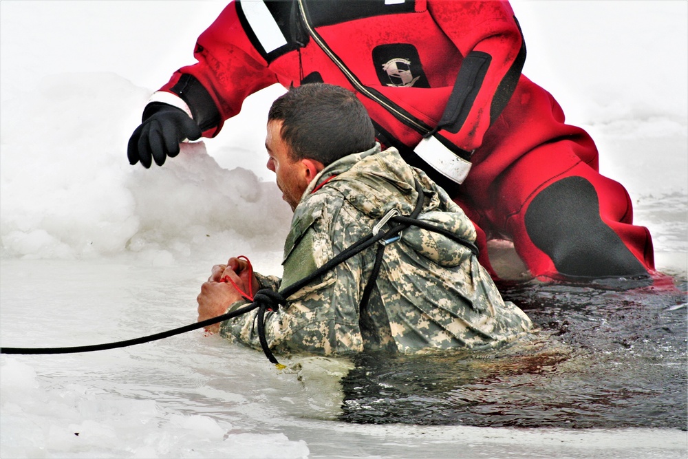 Airmen jump in icy Fort McCoy lake for January cold-water immersion training