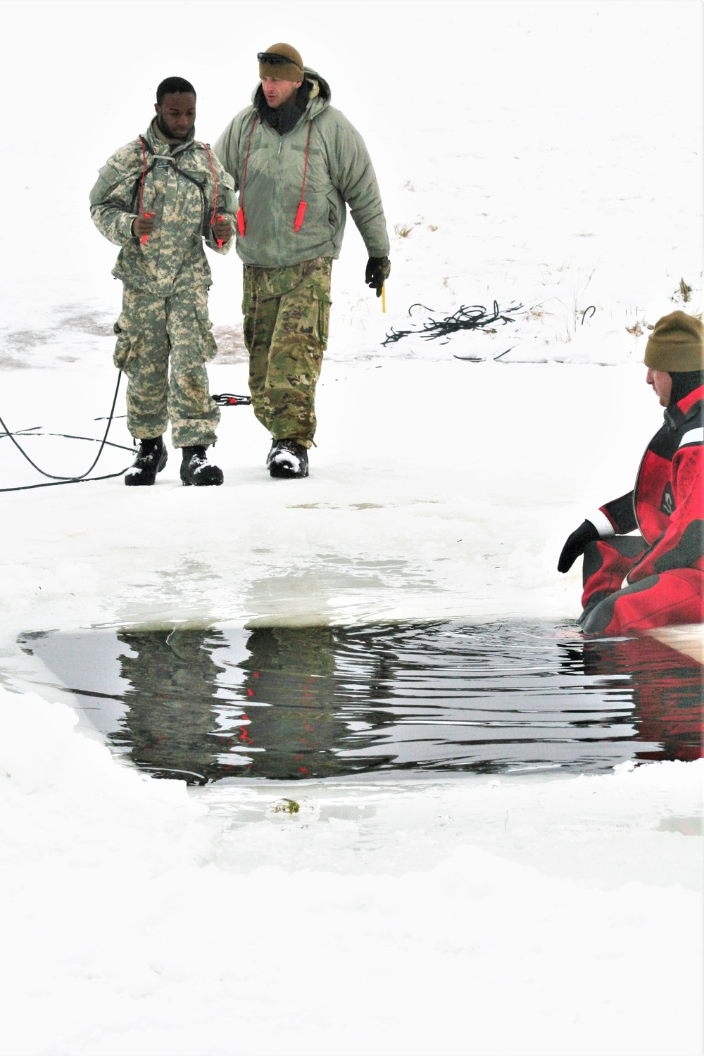 Airmen jump in icy Fort McCoy lake for January cold-water immersion training