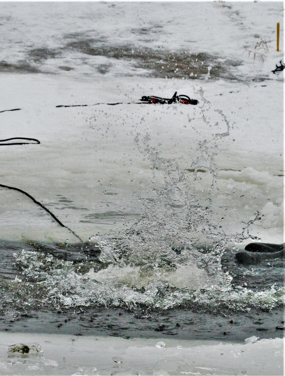 Airmen jump in icy Fort McCoy lake for January cold-water immersion training