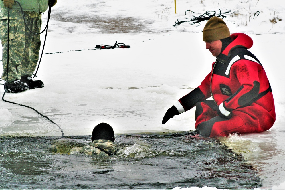 Airmen jump in icy Fort McCoy lake for January cold-water immersion training