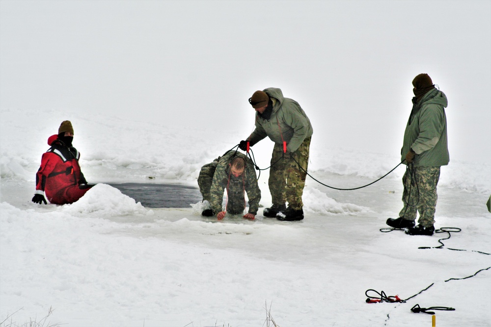 Airmen jump in icy Fort McCoy lake for January cold-water immersion training