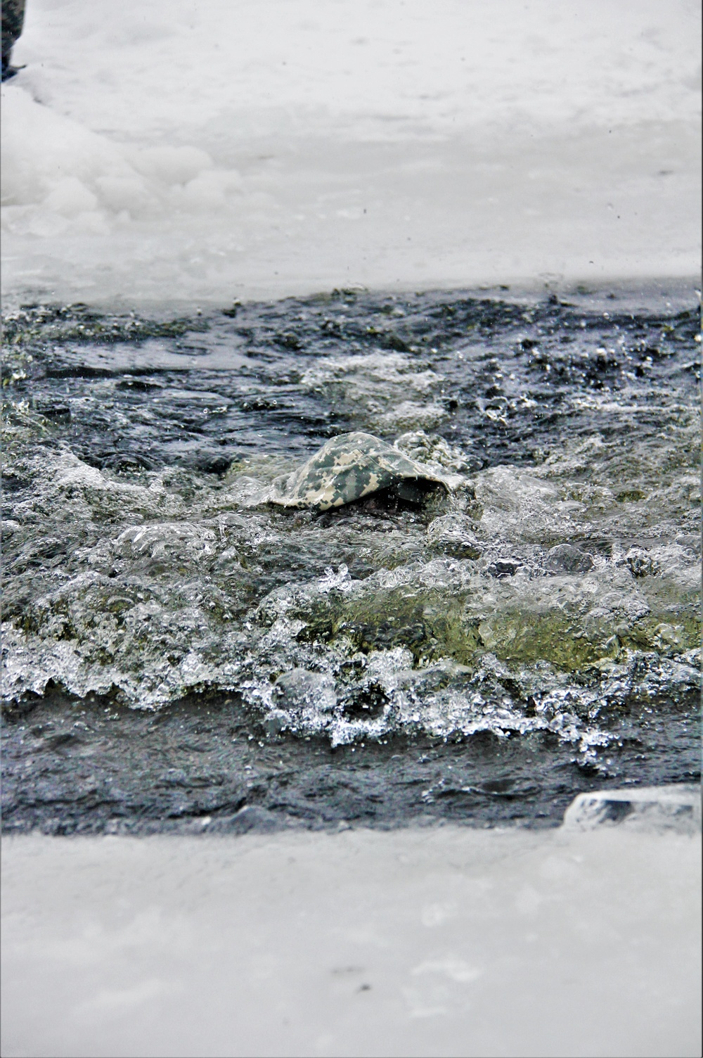 Airmen jump in icy Fort McCoy lake for January cold-water immersion training