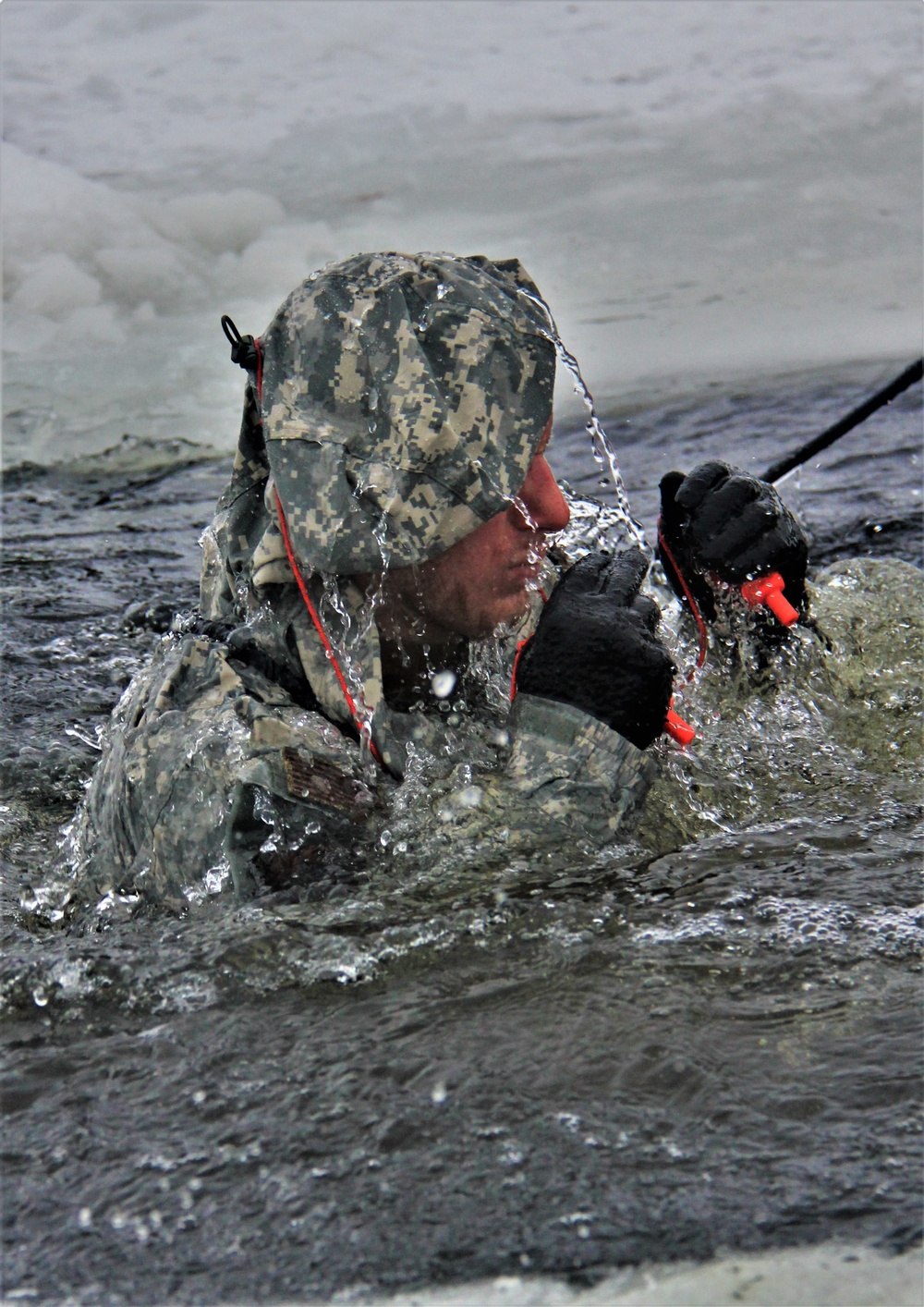 Airmen jump in icy Fort McCoy lake for January cold-water immersion training