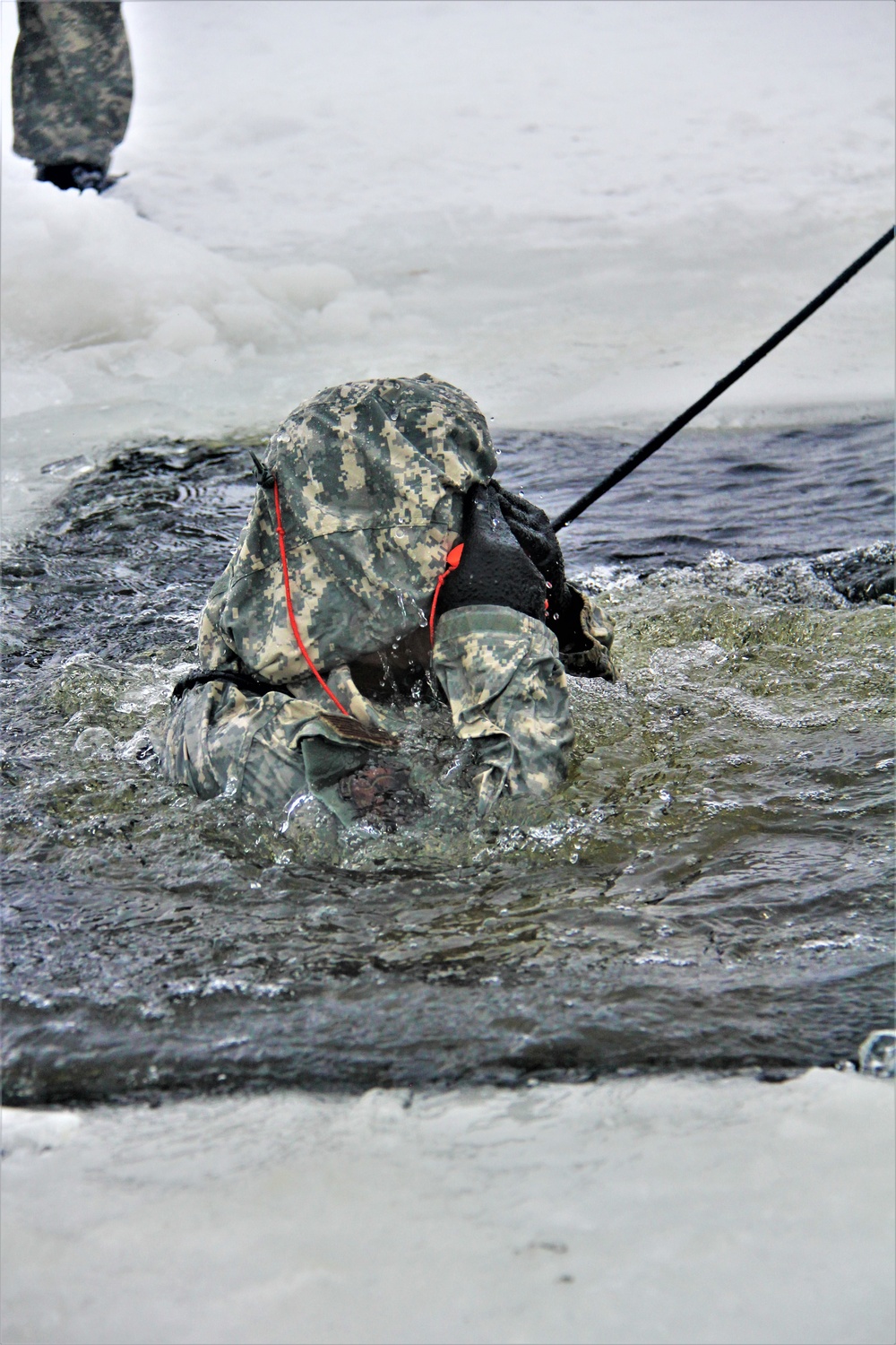 Airmen jump in icy Fort McCoy lake for January cold-water immersion training