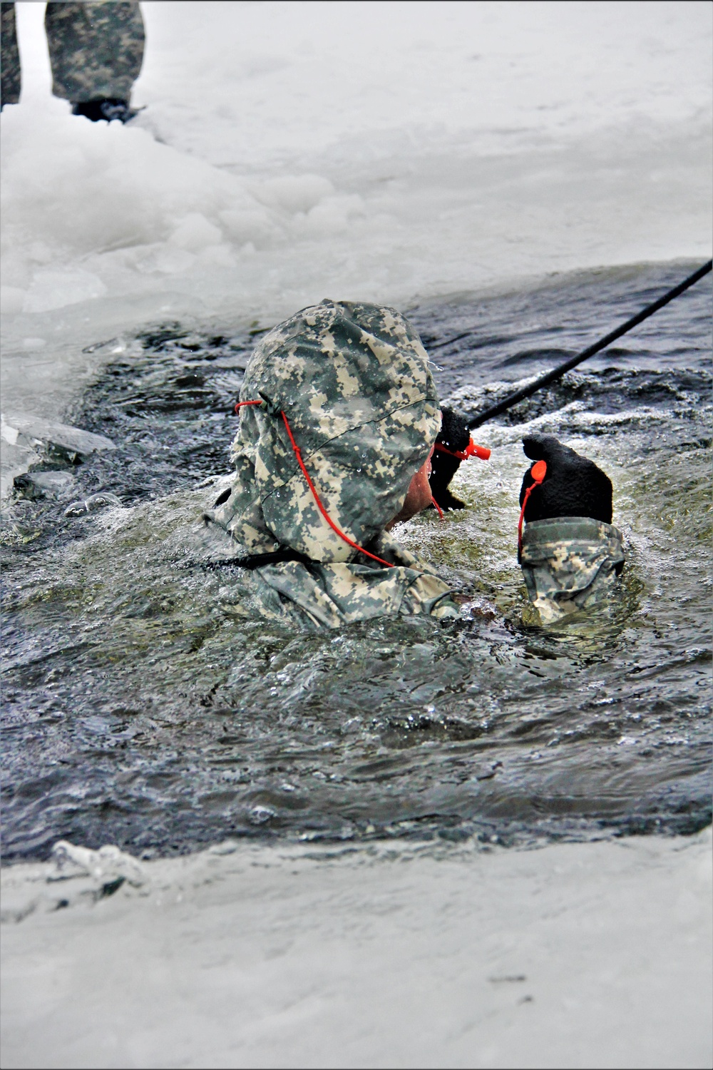 Airmen jump in icy Fort McCoy lake for January cold-water immersion training