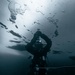 U.S. Navy Diver Drills Ice Pick Under The Ice