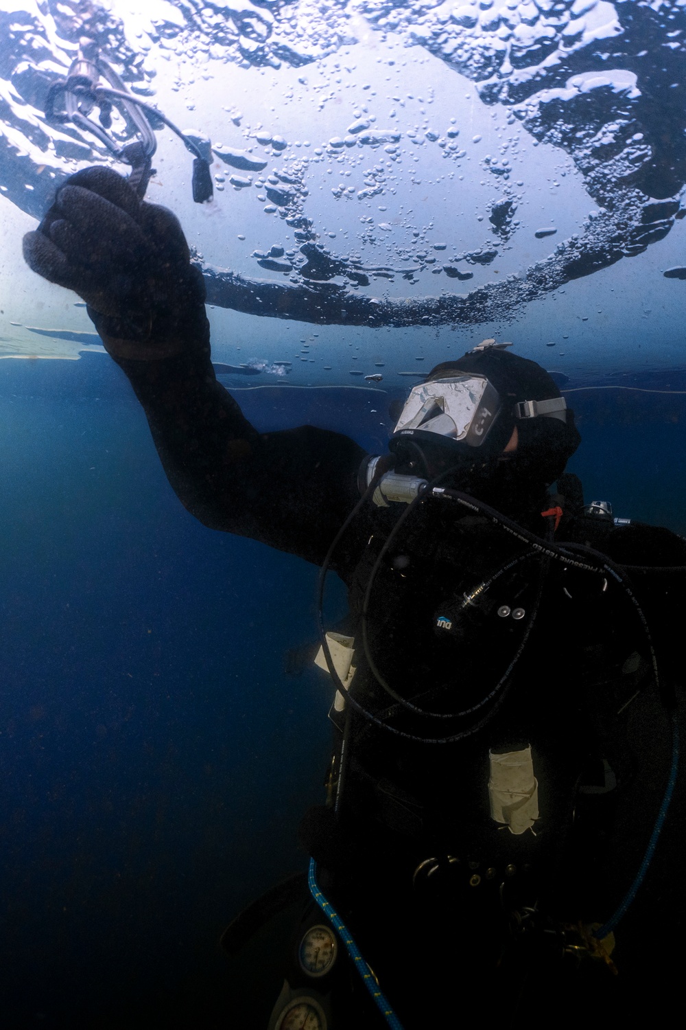 U.S. Navy Diver Drills Ice Screw Underneath Ice