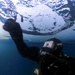 U.S. Navy Diver Drills Ice Screw Underneath Ice