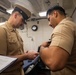 U.S. Navy Sailors conduct uniform inspection.