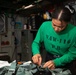 Sailor Inspects A Parachute Harness