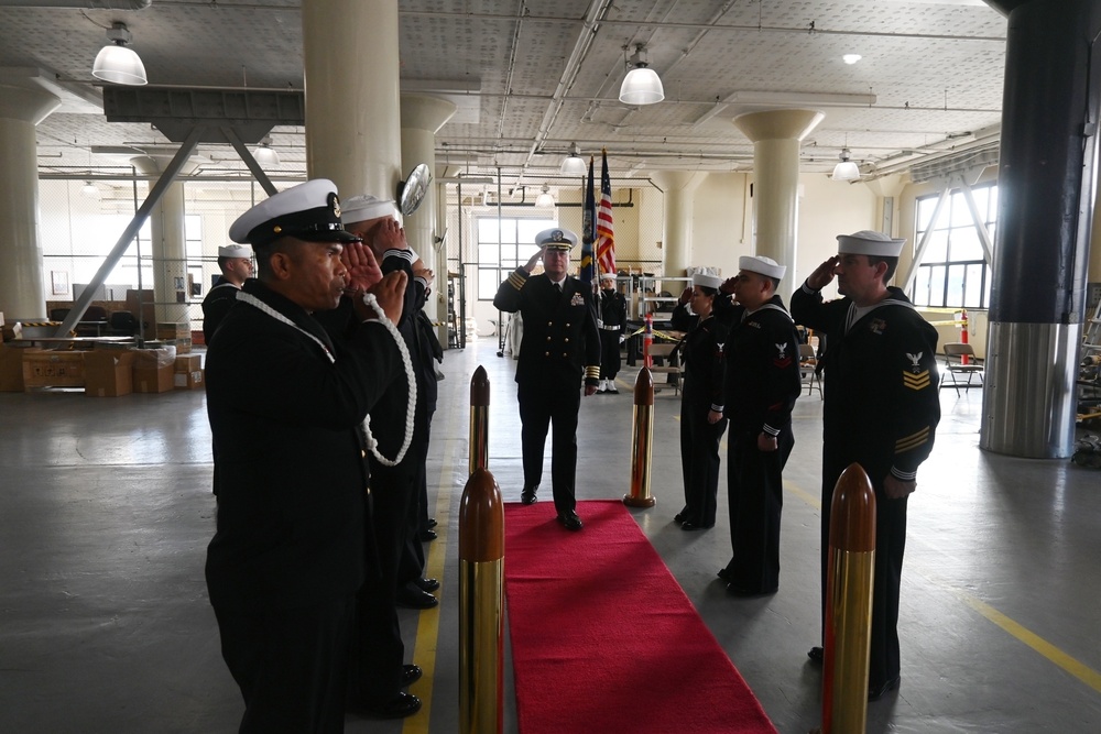 Capt. Ryan A. Baum salutes the side-boys and departs at the assumption of command ceremony as Commander, Navy Reserve, NAVSUP FLC San Diego