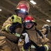 Sailors practice combating a fire casualty