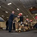 Sailors simulate a fire casualty during a general quarters drill