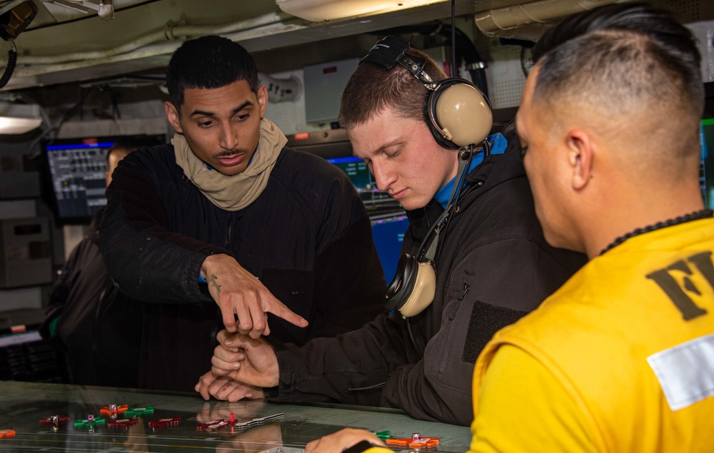 Sailors manipulate the Ouija board in Flight Deck Control
