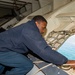 Sailor attaches the messenger in preparation for mooring in the Forecastle