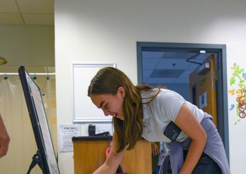 A YES Program Participants Meets Macy, a Brown Tree Snake Detection Dog